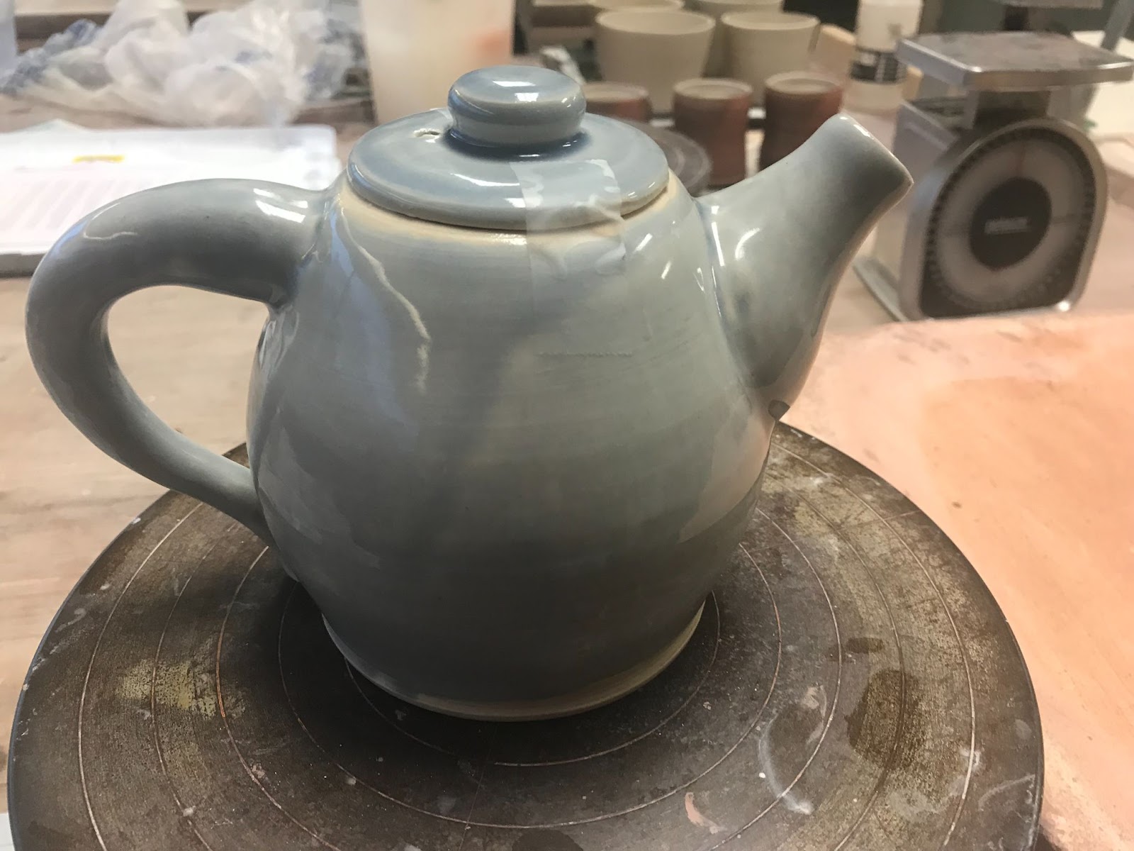 A taller, larger teapot, glazed a light stormcloud blue.