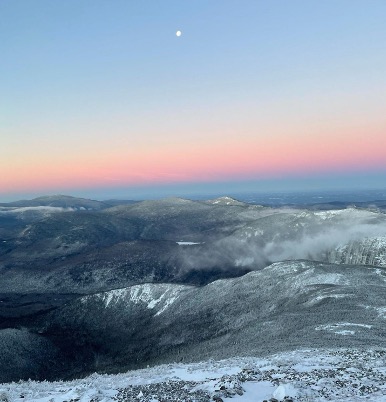 A wintry view of sunrise over the mountains.